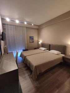 a hotel room with two beds and a television at Plaza Hotel in Alexandroupoli