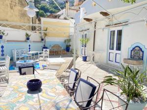 a patio with a table and chairs on a building at Positano Suite in Positano