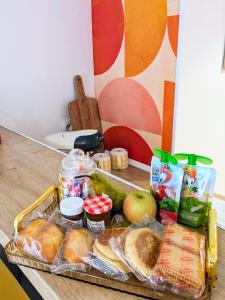 a tray of bread and other food on a counter at Appartement rétro proche Disneyland et Paris in Nanteuil-lès-Meaux