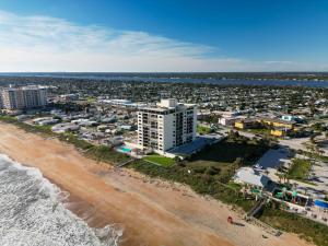 an aerial view of the beach and buildings at Sunrise beach views with top complex amenities and pool access! in Ormond Beach