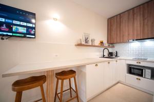 a kitchen with a counter and two stools at Petite haven in Split