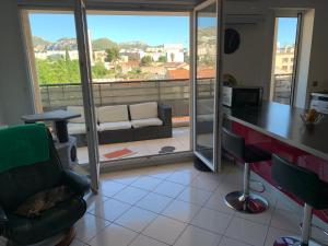 a living room with a view of a balcony at Droit au but!! in Marseille