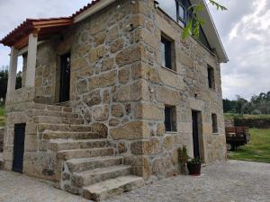 a stone building with stairs in front of it at Arpuro in Gouveia +28 photos