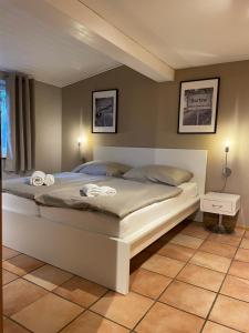 a bedroom with a large bed with two towels on it at Ferienhof Kunzog in Gartow