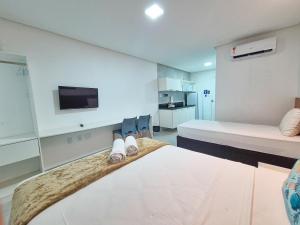 a hotel room with a bed and a tv at Porto Vila by AFT in Porto De Galinhas +55 photos