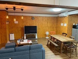 a living room with a blue couch and a table at Kojinjuku - Vacation STAY 46728v in Setouchi