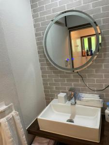 a bathroom with a white sink and a mirror at Kojinjuku - Vacation STAY 46728v in Setouchi