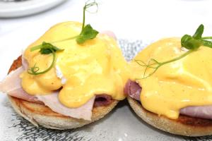 two sandwiches with ham and cheese on a plate at Langley Castle Hotel in Hexham