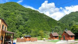 a group of wooden cabins in front of a mountain at New Kurumi Land - Vacation STAY 41991v 