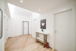 a hallway with white walls and a wooden floor at Tibur Domus B&B in Rome