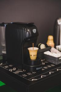 a coffee cup sitting on top of a espresso machine at Tibur Domus B&B in Rome