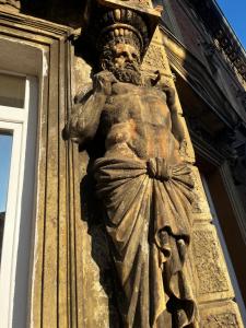 a statue on the side of a building at Apartment Cont in Rijeka