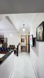 a hallway with a living room and a room with a couch at شقة للعائلات مفروشة in Taroudant