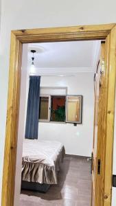 a bedroom with a bed in a room with a window at شقة للعائلات مفروشة in Taroudant