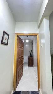 a hallway with a wooden door in a room at شقة للعائلات مفروشة in Taroudant