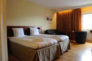 Ένα ή περισσότερα κρεβάτια σε δωμάτιο στο Grand Hotel Lapland
