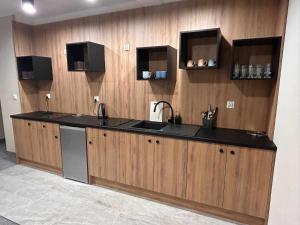 A kitchen or kitchenette at Resort EDEN - domki, pokoje, apartamenty