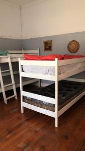 two white bunk beds in a room at Choice Guesthouse and Backpackers in Bulawayo