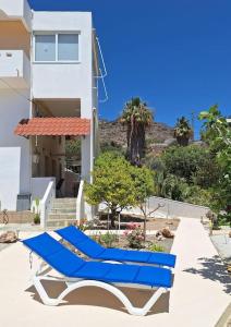 a blue lounge chair sitting on the side of a building at Achlia Sea Side Retreat 3 in Achlia +25 photos