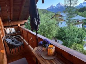 a balcony with a table and a view of mountains at Haus Kilian in Berchtesgaden