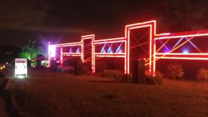 a lit up building with neon lights at night at Luxury Motel in Sorocaba