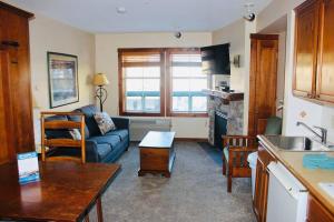 a kitchen and living room with a couch and a table at Close to Everything Ski In and Out in Snowshoe