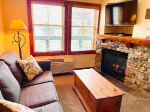 a living room with a couch and a fireplace at Close to Everything Ski In and Out in Snowshoe