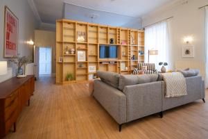 a living room with a couch and a television at The Ballroom - Huge Apartment in Lichfield City Centre in Lichfield