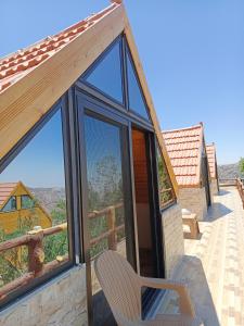 a room with a window and a chair on a balcony at Dana luxury huts in Dana