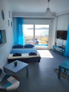 a bedroom with a bed and a view of the ocean at Upper Deck Apt. in Néa Péramos