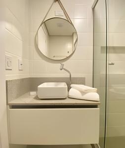 a bathroom with a sink and a mirror at Morcelli Mobiliados - Uniqo Smart Living in Santa Maria