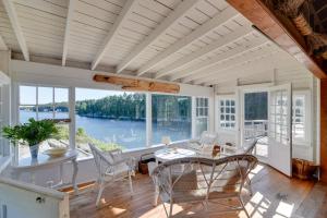 a dining room with a view of the water at Oceanfront Cottage with Deck 2 Mi to Boothbay Harbor in West Boothbay Harbor