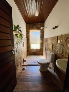 a bathroom with a toilet and a sink at Tropical Hostel in Pipa