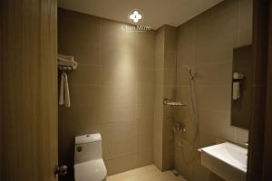 a bathroom with a shower and a toilet and a sink at Chun Mure Hotel in Dahan