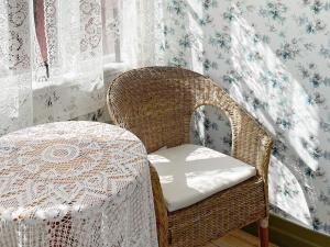 una silla de mimbre con una mesa en una habitación en Holiday home SÖLVESBORG XI, en Sölvesborg