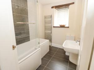 a bathroom with a toilet and a sink at Katie's Cottage in Skipton +18 photos