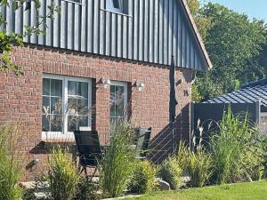 a brick building with a window on the side of it at Holiday apartment Beach Smile Lodge in Hohenfelde