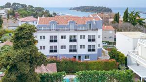a large white building with a red roof at Villa Grace in Rovinj