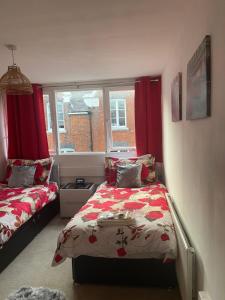 a bedroom with two beds and a window at Jeans Place Watergate St Rows near racecourse in Chester