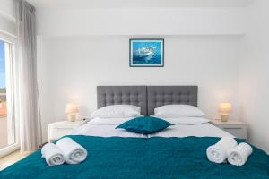 a bedroom with a large bed with towels on it at Villa Grace in Rovinj