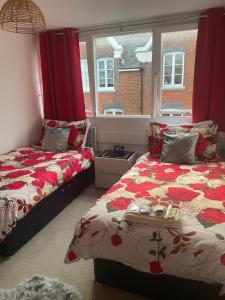 a bedroom with two beds and a window at Jeans Place Watergate St Rows near racecourse in Chester