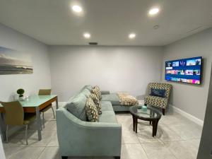 a living room with a couch and a table at Annas Peaceful Retreat Luxury Suite in Fort Lauderdale