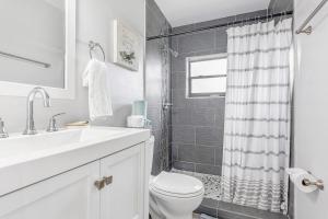 a bathroom with a sink and a toilet and a shower at Annas Peaceful Retreat Luxury Suite in Fort Lauderdale +29 photos
