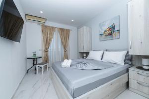 a bedroom with a large bed and a table at Apartmants Šestić in Tučepi