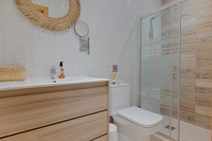a bathroom with a toilet and a sink and a shower at Casa Pitaya in Alhaurín el Grande +19 photos