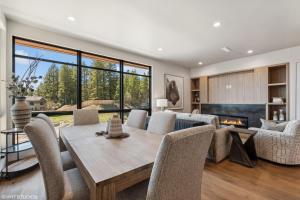 a dining room with a table and chairs and a fireplace at Discover Luxury at Cantera 303 in Whitefish