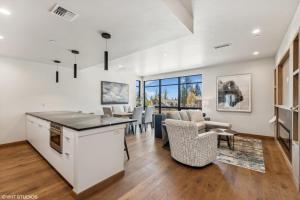 a kitchen and living room with a table and chairs at Discover Luxury at Cantera 303 in Whitefish