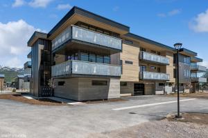 a building with a parking lot in front of it at Discover Luxury at Cantera 303 in Whitefish