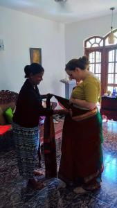 two women standing next to each other in a room at Kuma Beach side Villa in Wadduwa
