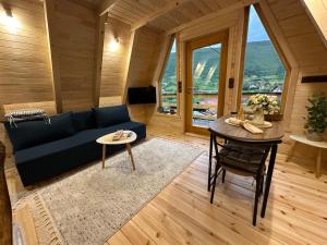 a living room with a blue couch and a table at Dream House Una in Orašac